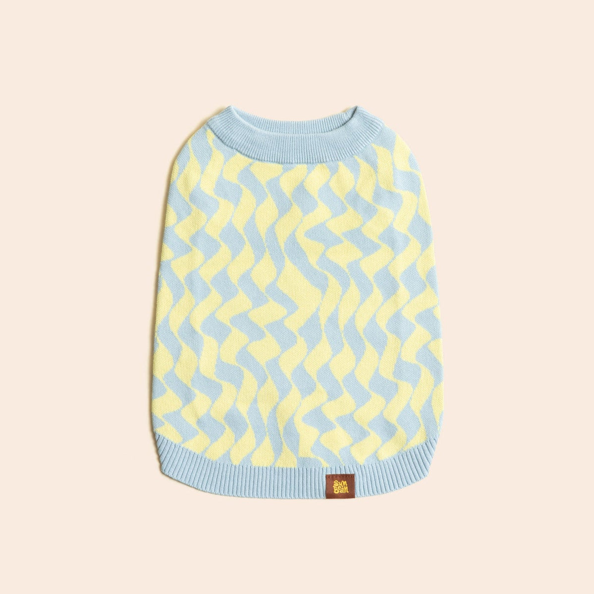 Dog sweater with blue and yellow pattern on a beige background