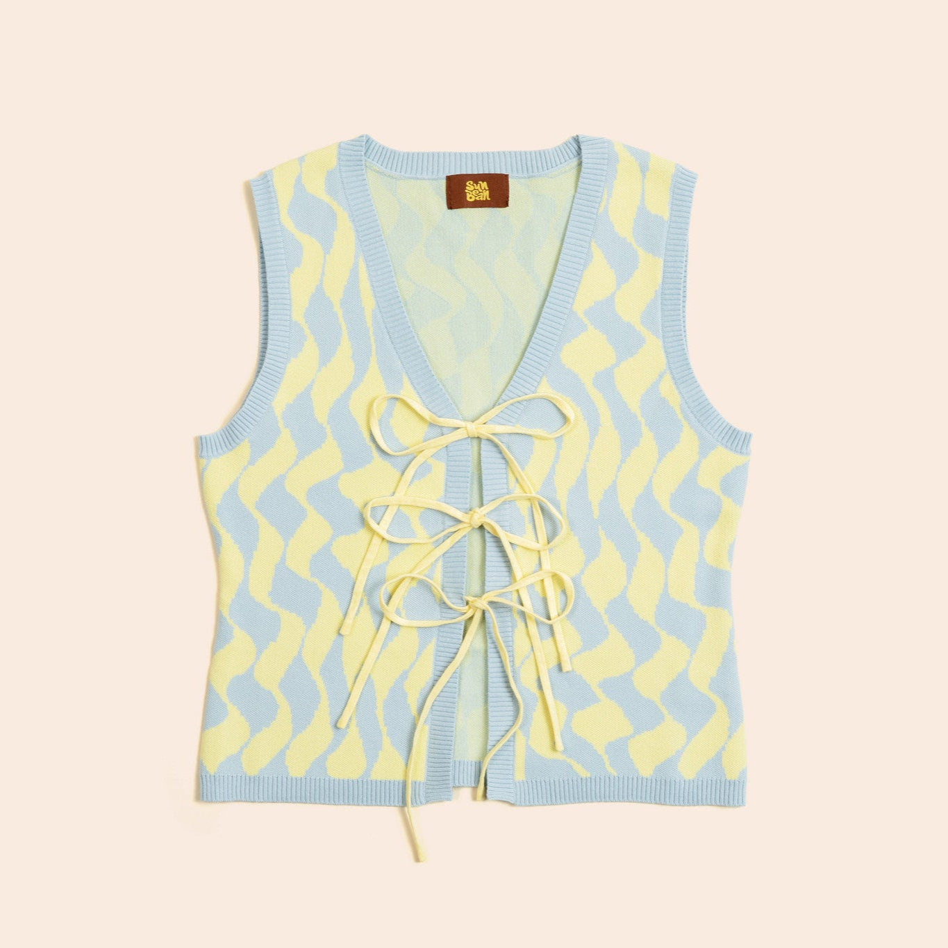 Light blue sleeveless top with yellow pattern and tie detail on a beige background
